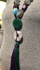 Dettaglio della collana indossata da Sabrina, da notare il bellissimo pendente centrale in pietra dura con nappa centrale in tripolina di seta bicolore, verde e viola. Tutto realizzato esclusivamente a mano.