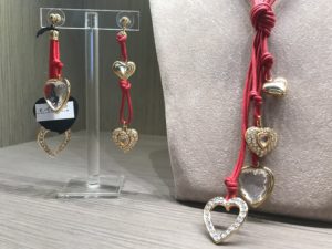 Piccola collana a frustina, in versione rosso lacca, realizzata artigianalmente con filato in cotone cerato e piccoli cuori con preziosi cristalli Swarovski, tutti montati a mano uno ad uno. Orecchini in parure.